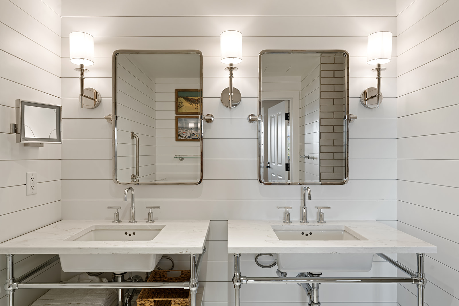 A clean and modern bathroom with a double vanity, two sinks, and two rectangular mirrors above them.